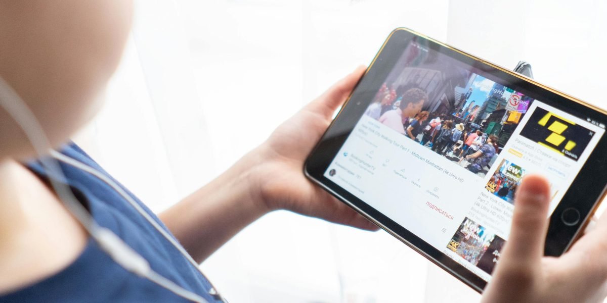 A person engaging with digital content on a tablet, symbolizing the ongoing need to stay current with rapidly evolving industry trends.