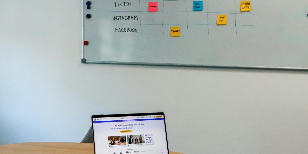 A focused digital marketer at a whiteboard, mapping out optimal advertising channels for different stages of the customer lifecycle.