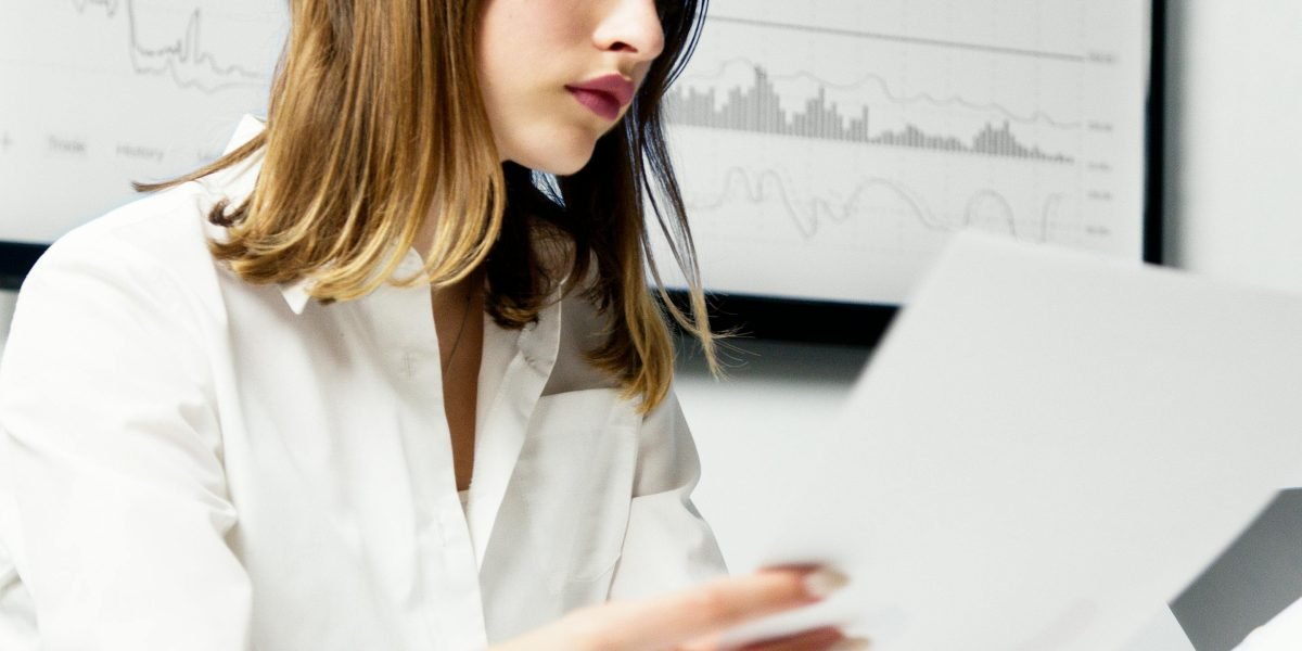 A person looks thoughtfully at complex data visualizations, leveraging AI-driven insights to refine advertising strategies.