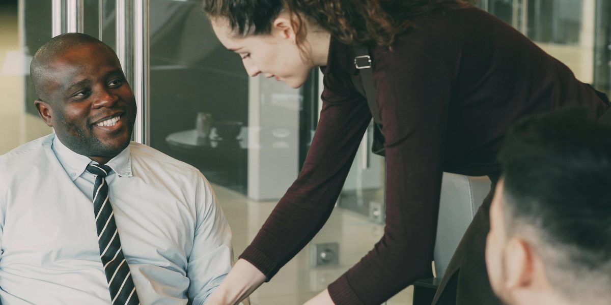 Marketing professionals in a focused discussion, emphasizing a customer-centric approach to build audience engagement.