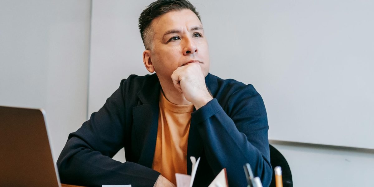 A person thoughtfully considering complex information, representing the need for strategic planning in a noisy digital world.