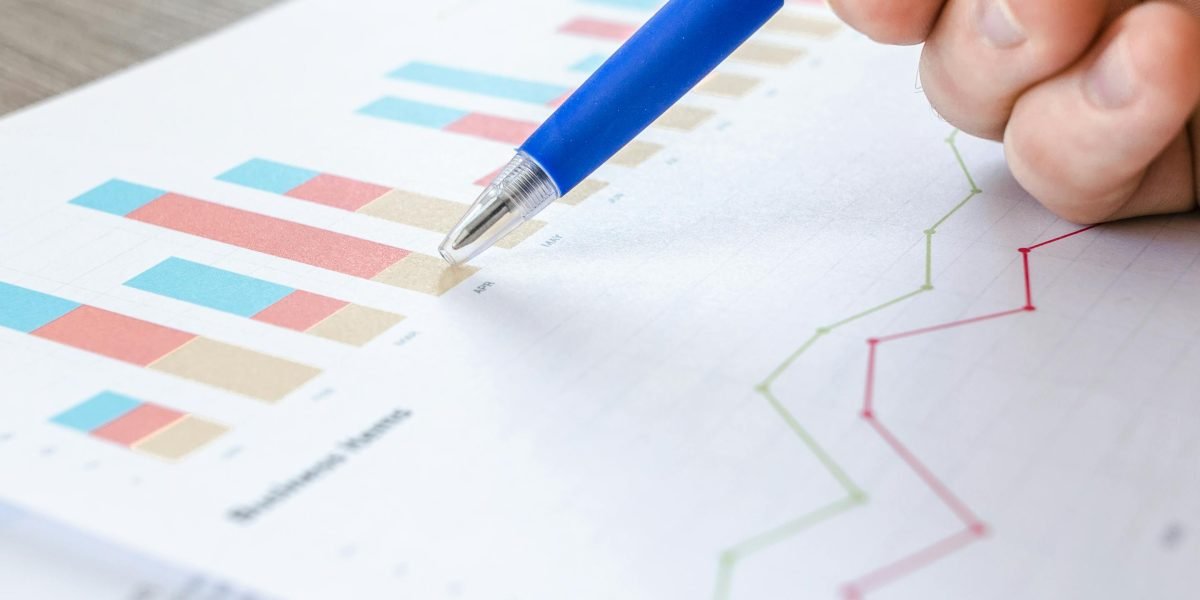 A focused individual reviewing reports and charts, symbolizing data-driven decision-making in marketing.