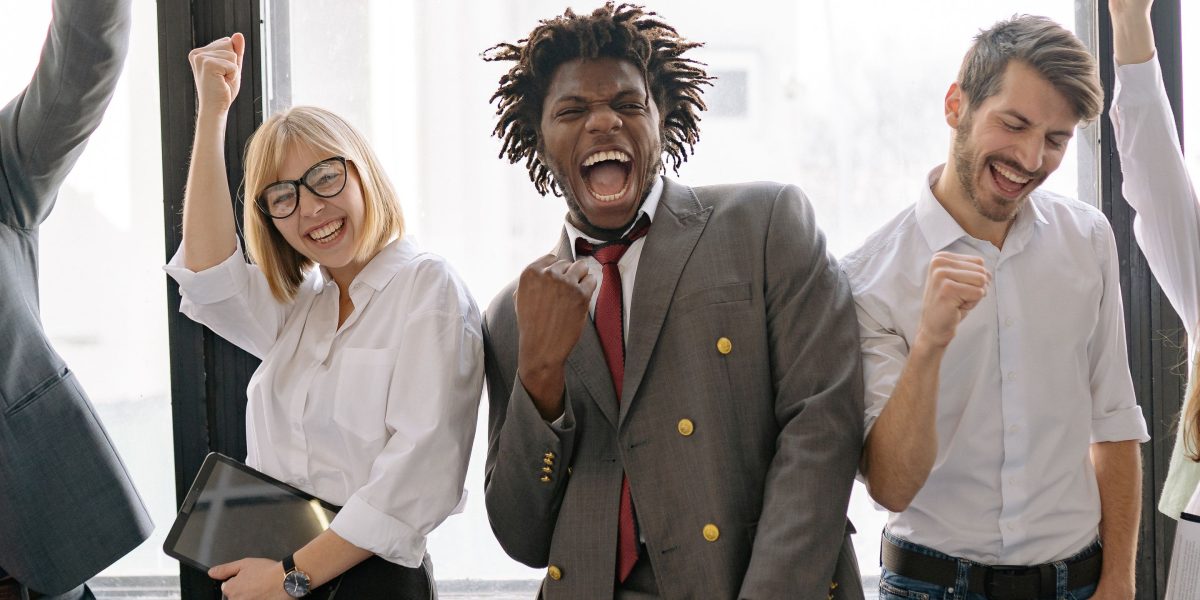 A cheerful team celebrating a project's successful outcome, reflecting the positive results of a well-executed marketing mix strategy.