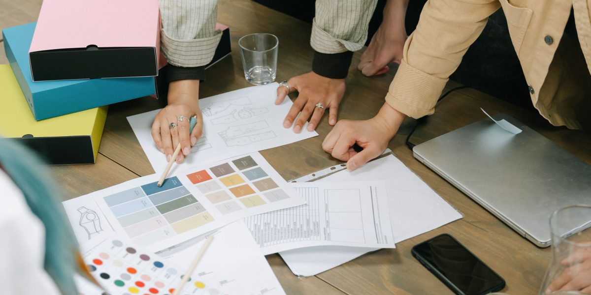 A team collaborating to ensure consistent brand identity across new products and formats.