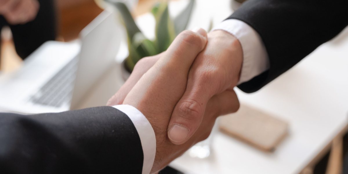 Business professionals concluding a partnership, symbolizing growth and strategic alliances.