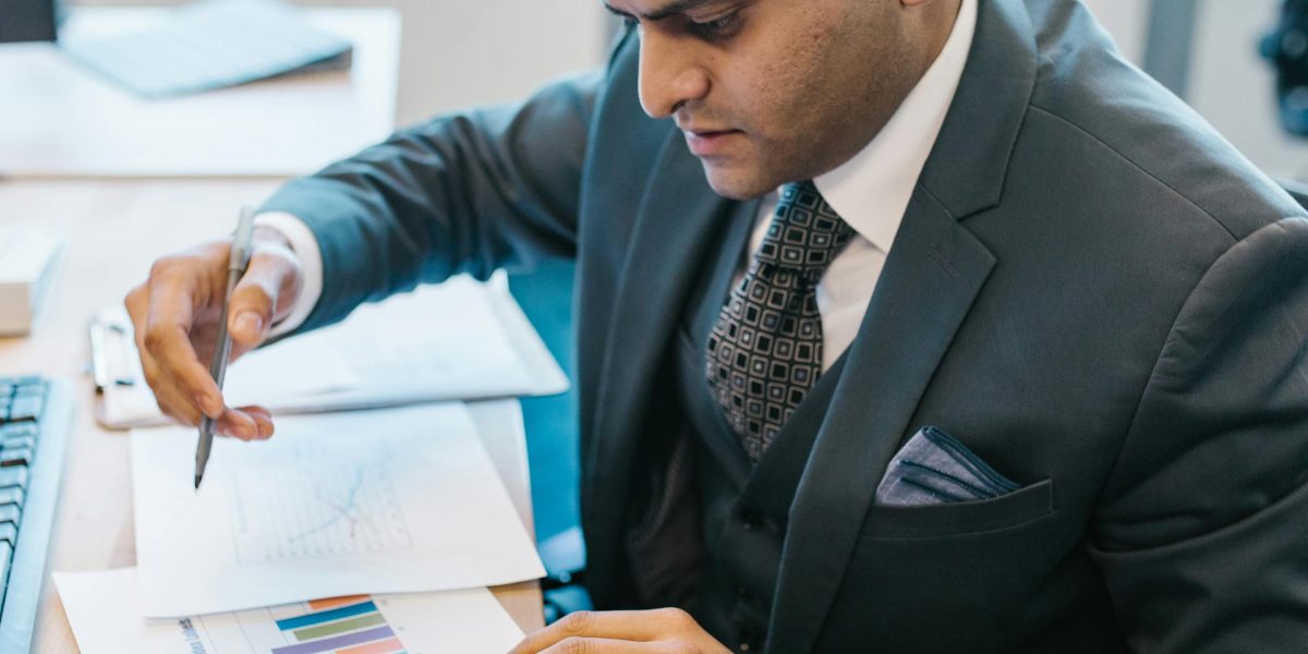An individual intently reviewing data on a screen, symbolizing the importance of measurement and attribution in marketing.