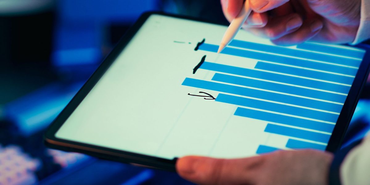 A professional reviewing analytics reports to optimize budgets and bidding for local advertising campaigns.
