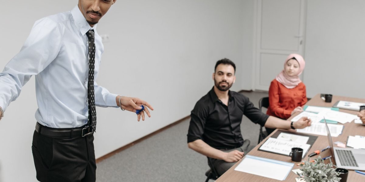 A professional presenting to colleagues, signifying knowledge sharing and the importance of expertise gained through certifications.
