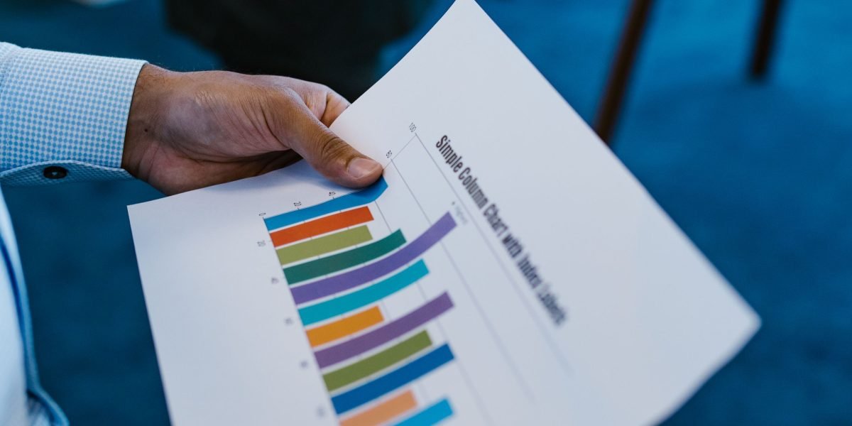 A person confidently presenting their work or portfolio during a meeting or interview.