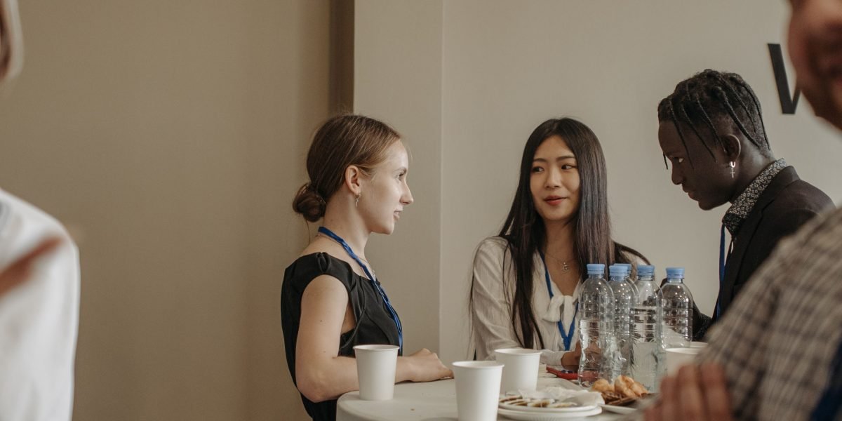 Professionals engaging in conversation, building connections at an industry event.