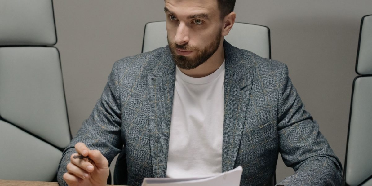 A business professional thoughtfully considering options and making a strategic choice.