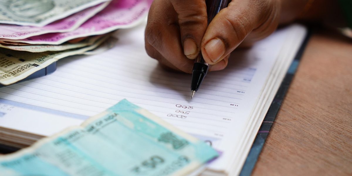 A person intently reviewing various documents, symbolizing the critical process of filtering information for strategic decisions.