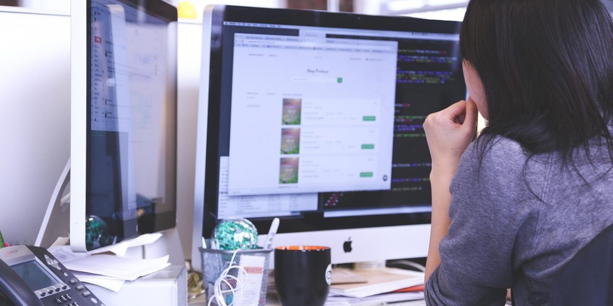 A marketing professional focused on a screen or documents, indicating deep analysis of audience demographics and behaviors.
