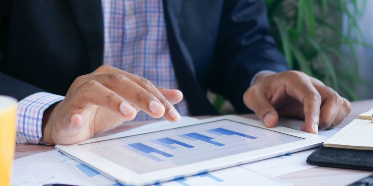 A professional meticulously analyzing various reports to interpret performance data.