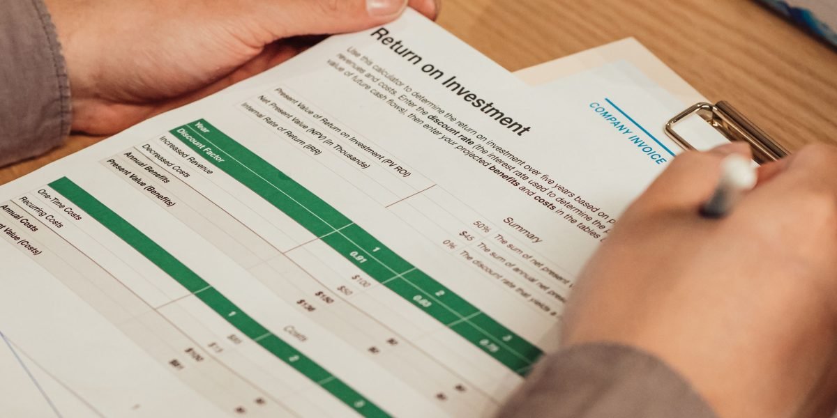 A professional meticulously reviews budget documents, considering various pricing models for agency services.