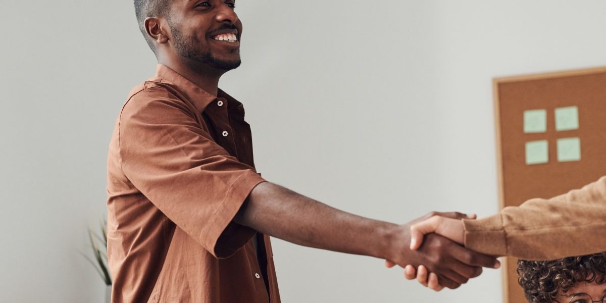Business professionals finalize an agreement, symbolizing the start of a new agency-client relationship.