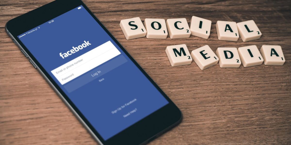 A person engaged with social media on their phone, illustrating modern digital content consumption and influence.