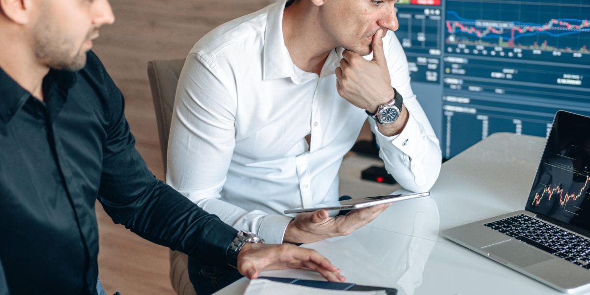 Marketing professionals meticulously examining charts and data to evaluate campaign performance.