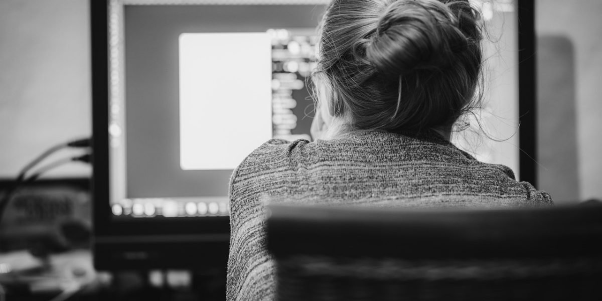 A designer working alongside AI tools, enhancing creativity and efficiency in ad production.