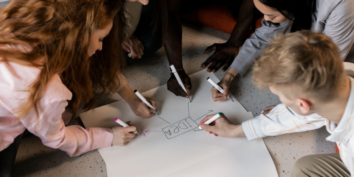 A creative team collaborates, discussing ideas to craft compelling and memorable advertising messages.