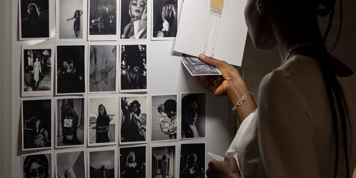 A creative designer actively sketching and brainstorming ad ideas on a whiteboard, focusing on large-format visuals.