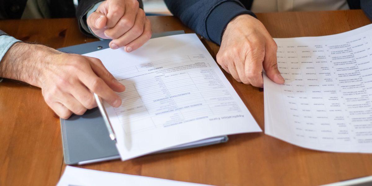 Professionals review a contract, carefully considering the terms before finalizing a partnership.