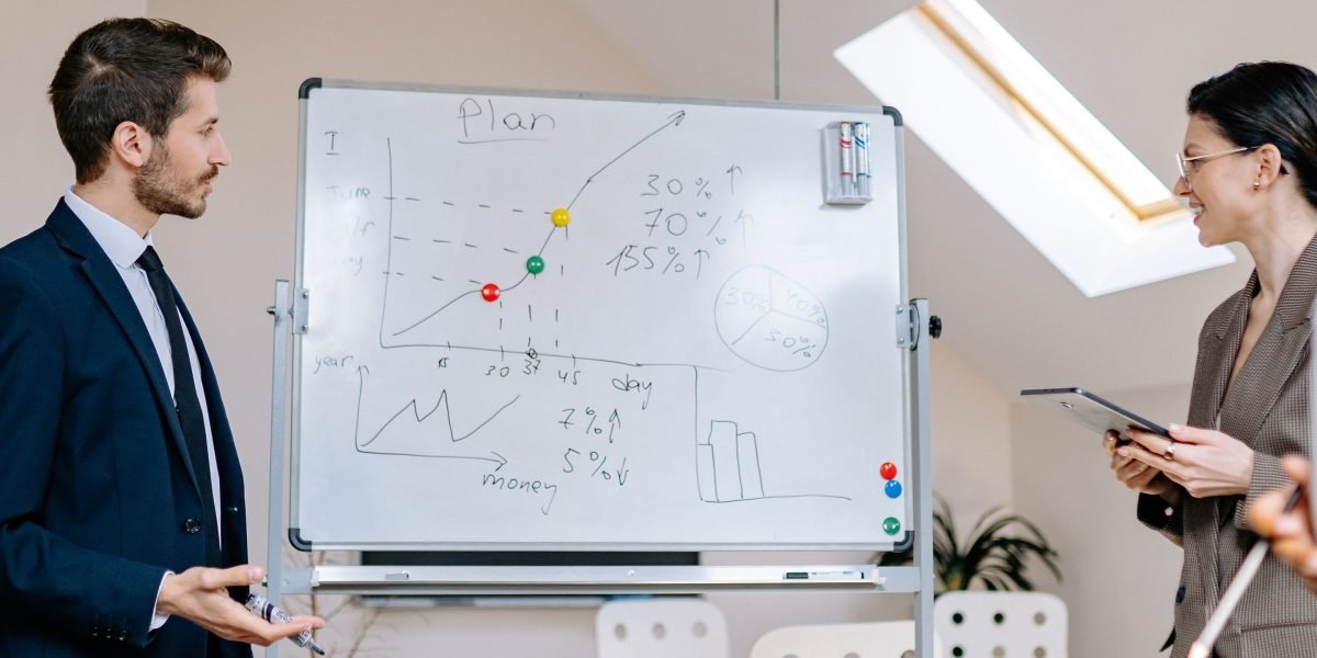 A team planning and strategizing on a whiteboard, emphasizing a deliberate approach.