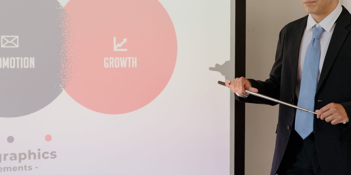 A professional presenting project progress and insights to a team, showcasing leadership and communication.