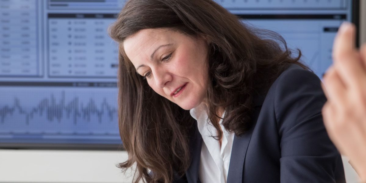 A professional analyzing a data dashboard to track marketing campaign performance and key performance indicators (KPIs).