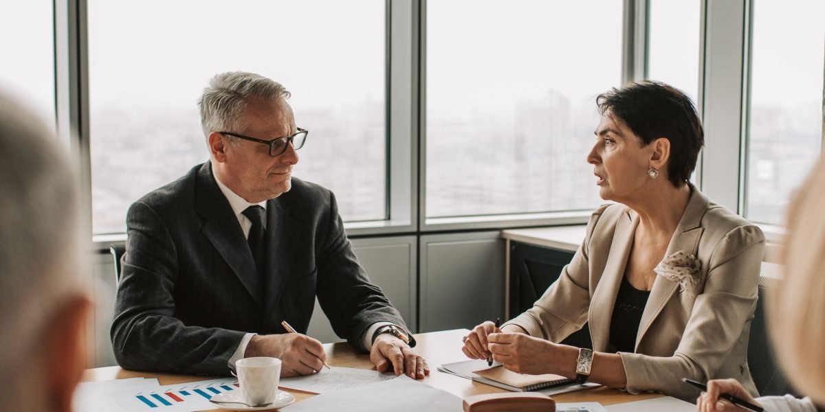 Professionals in an office setting discussing the complexities and challenges of modern advertising.