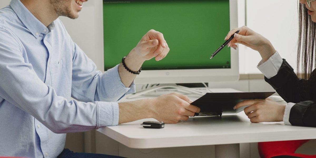 A marketing manager presenting campaign strategies to a client in a bright meeting room.
