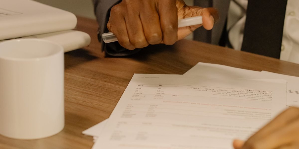 A professional business person confidently reviewing a contract at a desk, emphasizing careful decision-making.