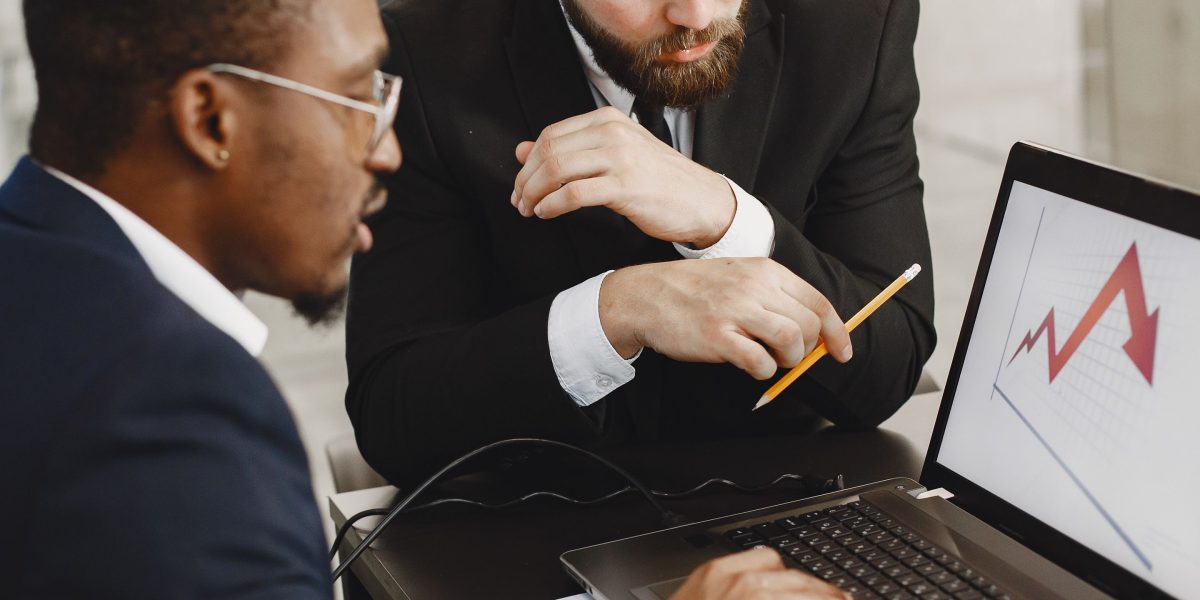A business team in an energetic discussion, analyzing campaign results beyond superficial metrics to understand true business growth.