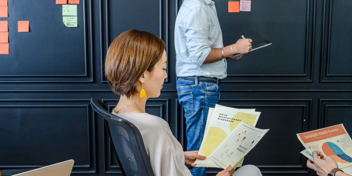 A team collaborates in a meeting room, actively discussing and strategizing for new marketing approaches.