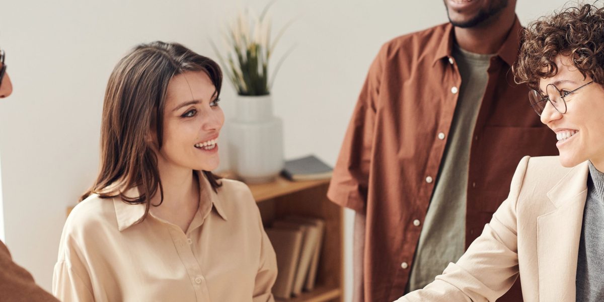 Two professionals engaged in a positive interaction, symbolizing strong sales and marketing team alignment.