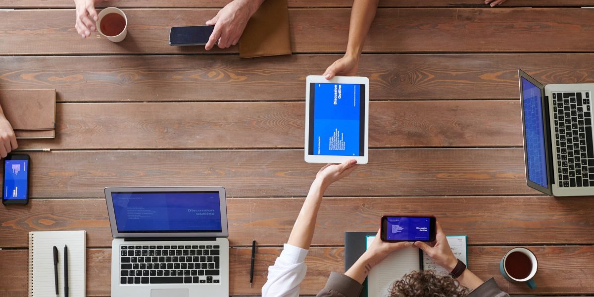 A marketing team effectively integrates technology and AI tools into their workflow, collaborating on a shared digital platform.