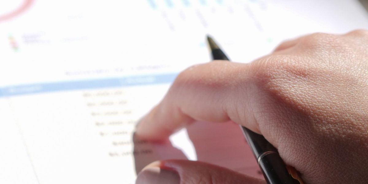A professional reviews dashboards and reports to evaluate marketing team performance and identify key insights.