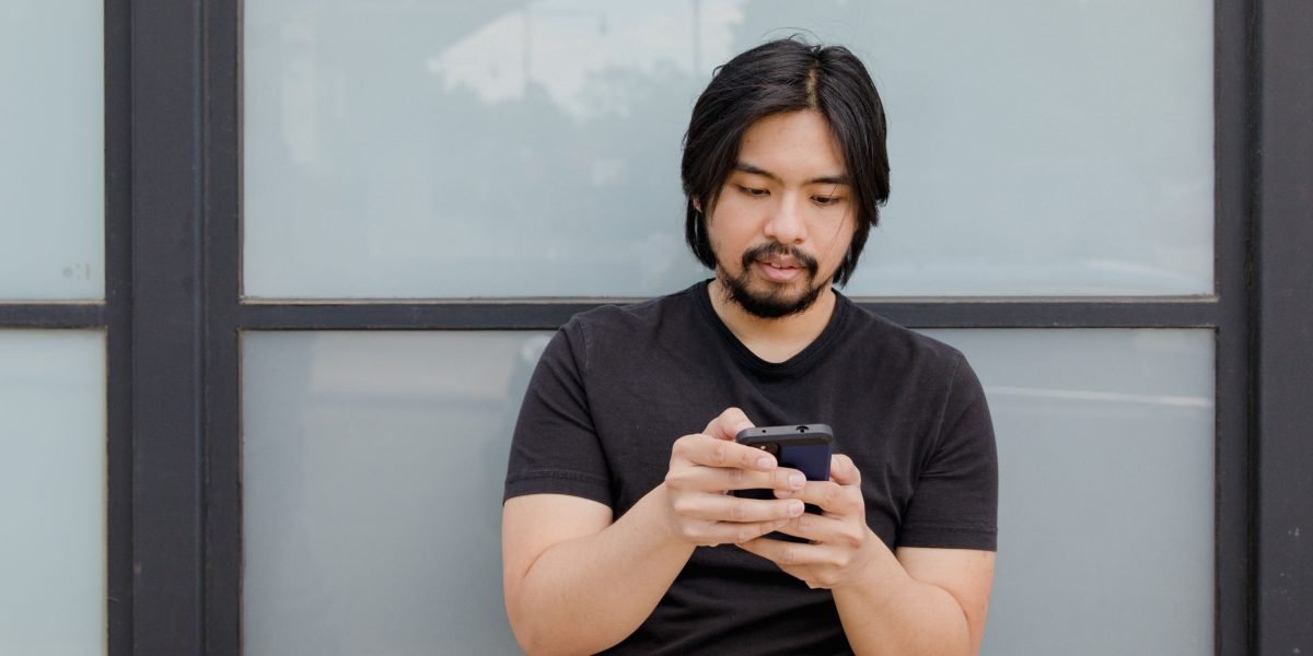 A person easily and confidently interacting with a website on their smartphone, highlighting a positive mobile experience.