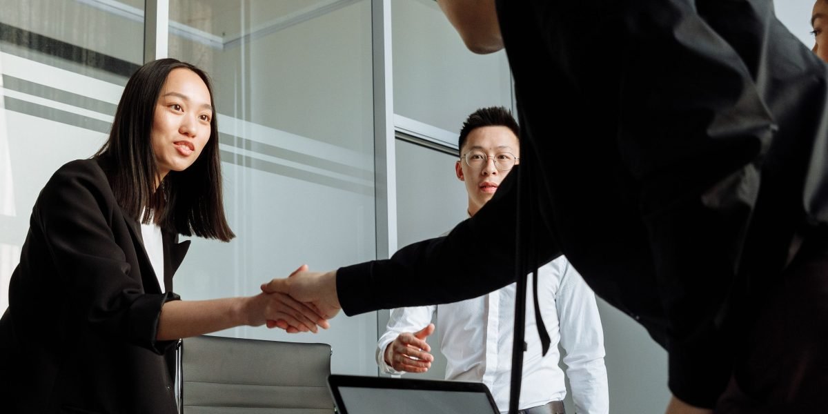Professionals engaged in a serious business discussion, potentially concluding with a handshake.